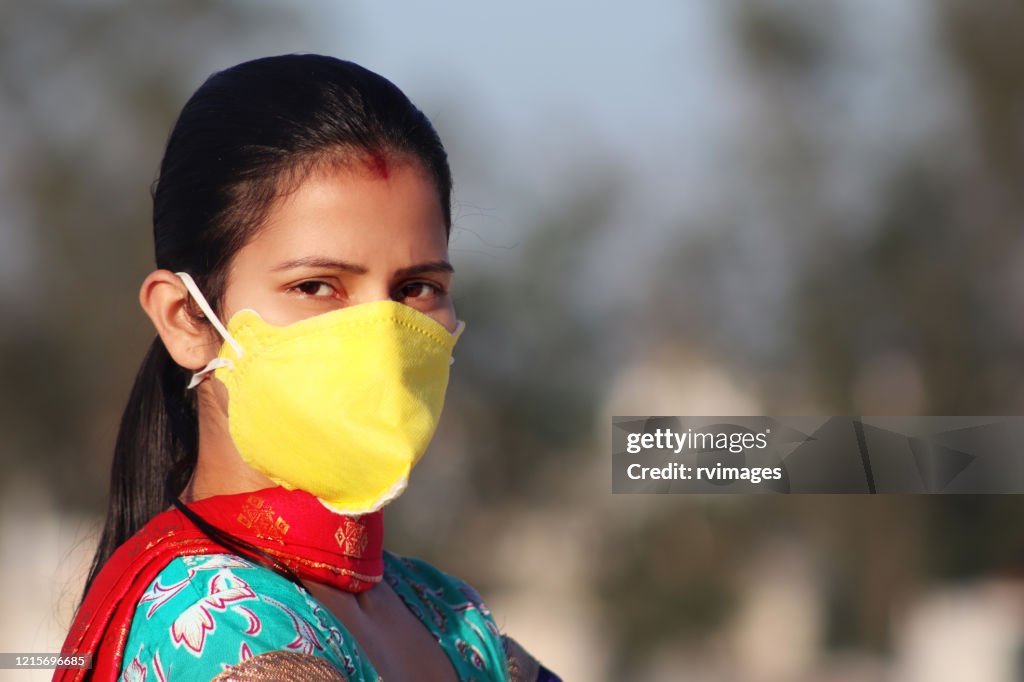 Women covering her face with pollution mask for protection from viruses