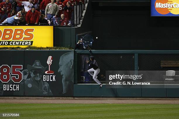 Endy Chavez of the Mets leaps but can't reach a home run by Cardinals starter Jeff Suppan during game 3 of the NLCS between the New York Mets and St....