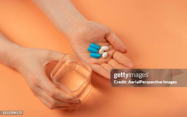 holding pill in hand with water - prozac stock pictures, royalty-free photos & images