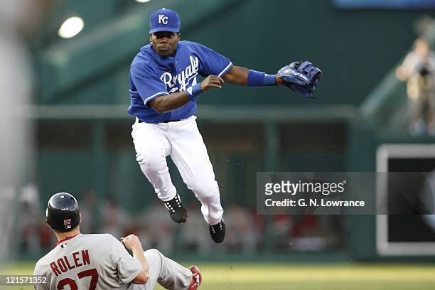 Angel Berroa of the Royals throws over Scott Rolen during action between the St. Louis Cardinals and Kansas City Royals at Kauffman Stadium in Kansas...