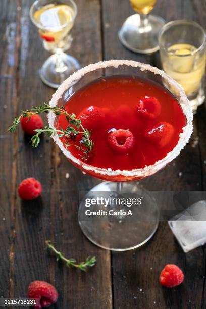 alcoholic drink with gin, raspberries and thyme. - raspberry cocktail stock pictures, royalty-free photos & images