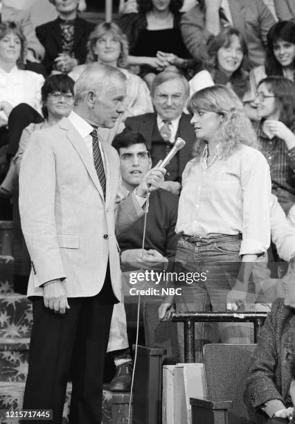 Pictured: Host Johnny Carson and audience member Kim Bogan during segment "Stump the Band" on January 5, 1984 --