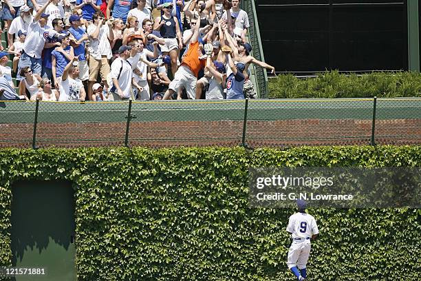 Cubs outfielder Juan Pierre watches an Edgar Renteria home run fall into the bleachers during action between the Atlanta Braves and Chicago Cubs at...