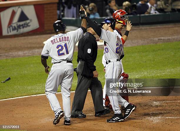 Carlos Delgado and Shawn Green of the Mets score in the 4th inning on a double by Jose Valentine during game 5 action of the NLCS between the New...