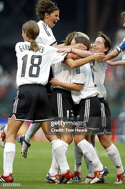 Kerstin Garefrekes of Germany celebrates with teammates after scoring a goal on Russia October 2 at PGE Park in Portland, Oregon. Germany defeated...