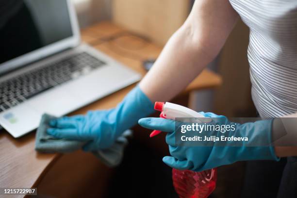 wiping down surfaces at house, covid-19 - wiping down desk stock pictures, royalty-free photos & images