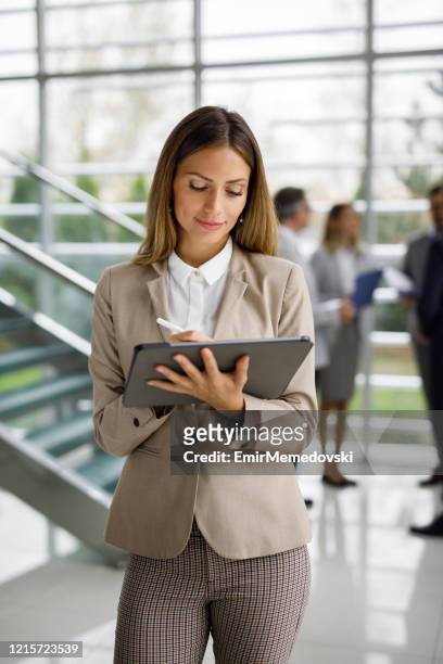 young businesswoman with digital tablet at work - incidental people stock pictures, royalty-free photos & images