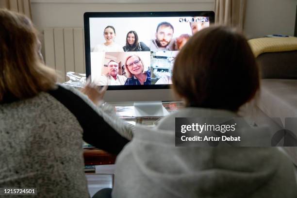 doing multiple video call with family during home quarantine for the coronavirus in spain. covid-19. - video chat stock-fotos und bilder