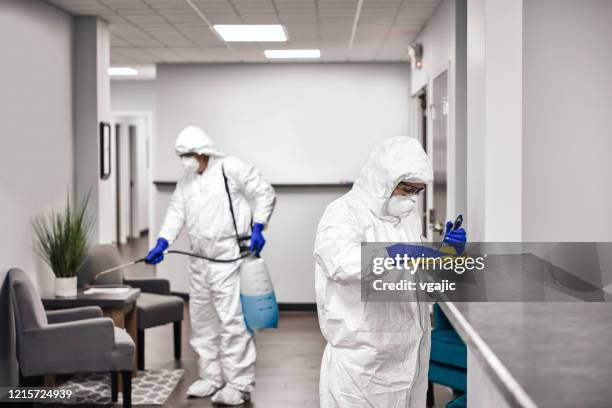 cleaning and disinfecting office - teamwork covid stock pictures, royalty-free photos & images