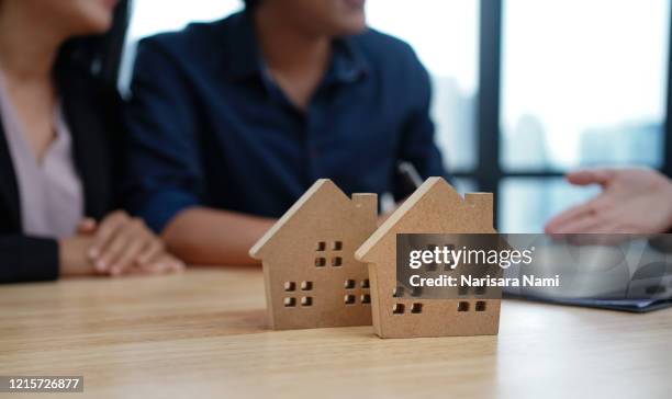 loan,contract, debt and residential investment concept. contract of loan and estate agreement for investor or buyer to sign for getting approval form the bank. - estate agency stock pictures, royalty-free photos & images