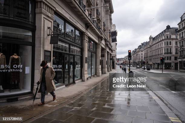 Man walks up a deserted Regent Street on March 30, 2020 in London, England. The Coronavirus pandemic has spread to many countries across the world,...