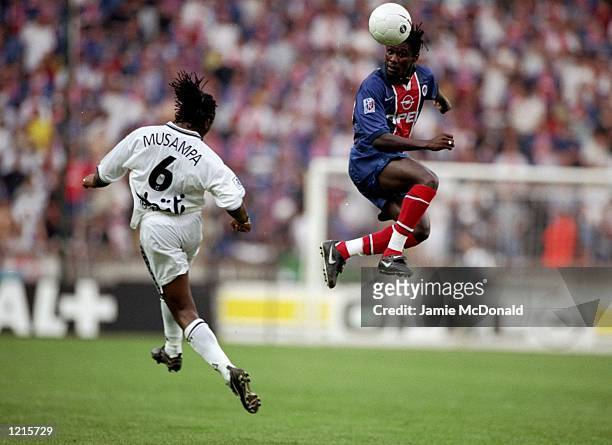 Aliou Cisse of Paris St Germain rises above Kiki Musampa of Bordeaux during the French Division One match at the Parc des Princes in Paris. Bordeaux...