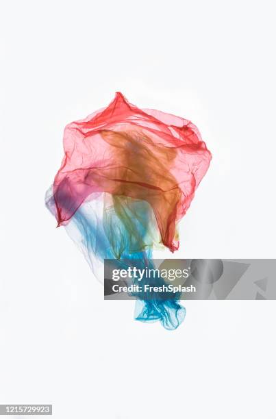 thrown away and polluting: crumpled used colourful plastic bags - plastic bag stock pictures, royalty-free photos & images