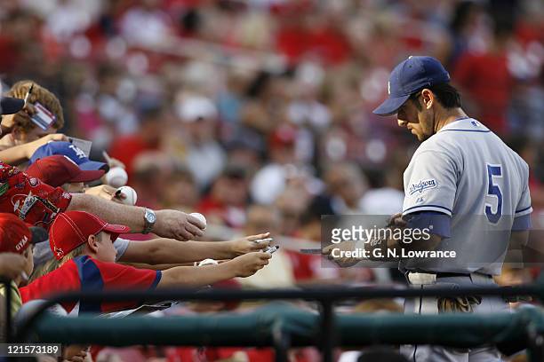 The Dodgers Nomar Garciaparra signs autographs prior to action between the Los Angeles Dodgers and St. Louis Cardinals at Busch Stadium in St. Louis,...