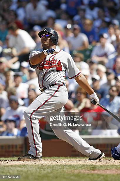 Andruw Jones of the Braves admires his home run hit onto Waveland Avenue during action between the Atlanta Braves and Chicago Cubs at Wrigley Field...