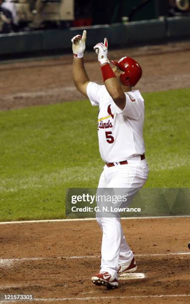 Albert Pujols of St. Louis crosses the plate after hitting a solo home run during game 5 action of the NLCS between the New York Mets and St. Louis...