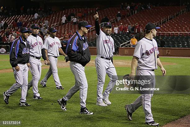 Mets pitcher Jose Lima raises his arm in victory as the team walks off the field after beating the St. Louis Cardinals 8-3 at Busch Stadium in St....
