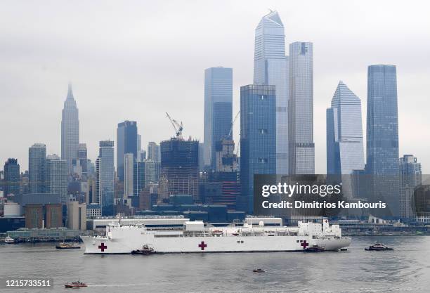 Navy Hospital Ship USNS Comfort travels up the Hudson River as it heads to Pier 90 as the coronavirus pandemic continues to overwhelm medical...