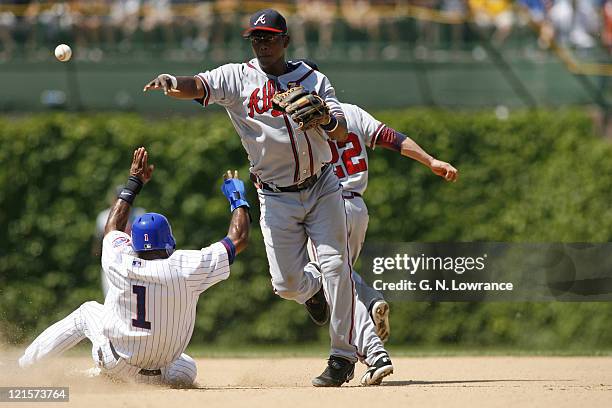 Edgar Renteria of Atlanta completes a double play during action between the Atlanta Braves and Chicago Cubs at Wrigley Field in Chicago, Illinois on...