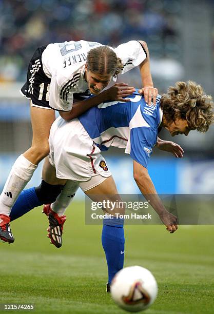 Kerstin Garefrekes of Germany collides with Marina Burakova of Russia during game action October 2 at PGE Park in Portland, Oregon. Germany defeated...