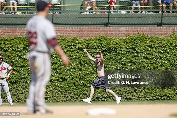 Fan runs on the field during action between the Atlanta Braves and Chicago Cubs at Wrigley Field in Chicago, Illinois on May 28, 2006. The Braves won...