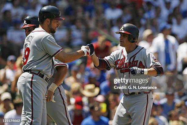 Marcus Giles, right, is congratulated by pitcher John Smoltz after belting a home run during action between the Atlanta Braves and Chicago Cubs at...