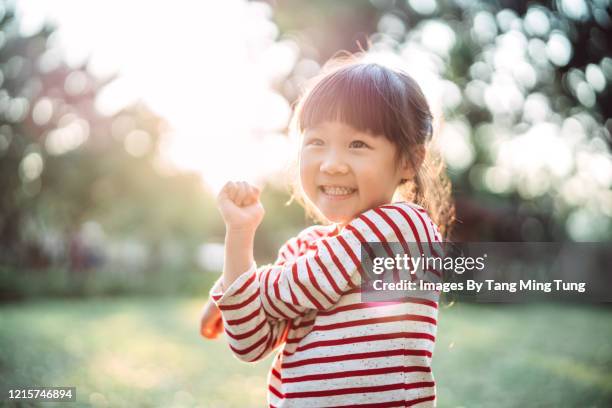 young family doing stretching exercises on the lawn joyfully - 5 years stock pictures, royalty-free photos & images