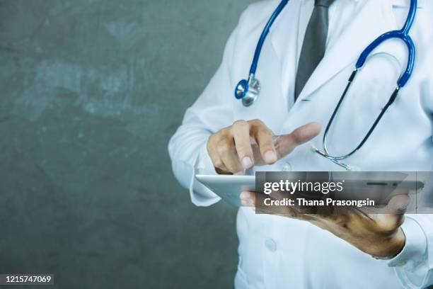 coronavirus-doctor holding tablet with futuristic hud screen tablet. covid-19 - infectious disease contact diagram stock pictures, royalty-free photos & images