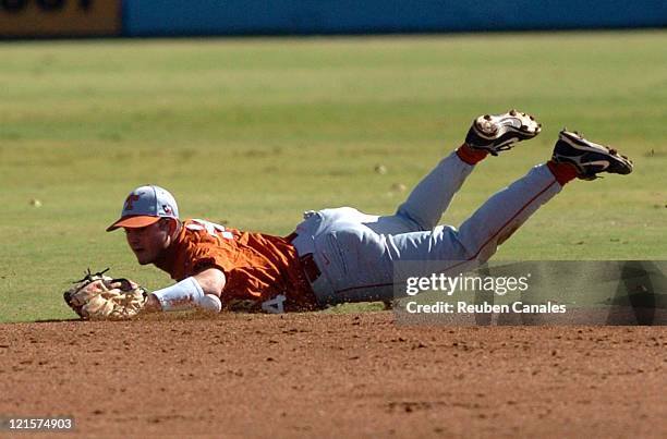 Second baseman Travis Tucker of the University of Texas Longhorns misses the ball after a dive in a 2 to 1 win over the Long Beach State Dirtbags on...