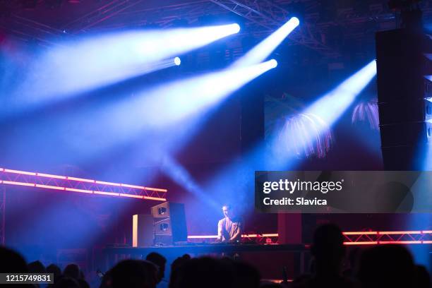 dj playing techno music on the stage - dance music stock pictures, royalty-free photos & images