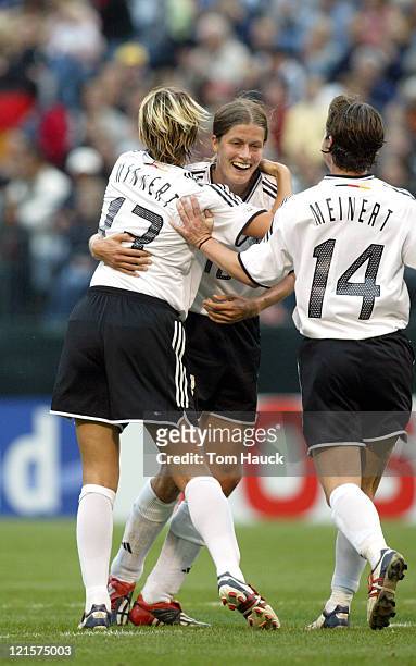 Kerstin Garefrekes of Germany celebrates with teammates after scoring a goal on Russia October 2 at PGE Park in Portland, Oregon. Germany defeated...