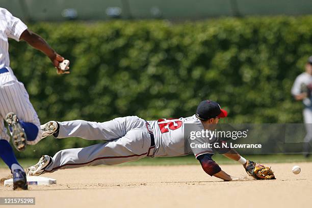 Marcus Giles can't field a bad throw by Edgar Renteria during action between the Atlanta Braves and Chicago Cubs at Wrigley Field in Chicago,...