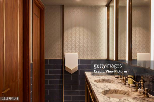 Detail of communal toilet interior with wash basins. Indigo Hotel, Leicester Square, London, United Kingdom. Architect: Michaelis Boyd Associates...