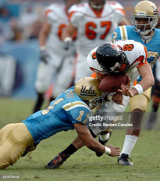 Free Safety Dennis Keyes of the UCLA Bruins tackles Beavers quarterback Matt Moore causing a fumble in a 25 to 7 victory over the Oregon State...