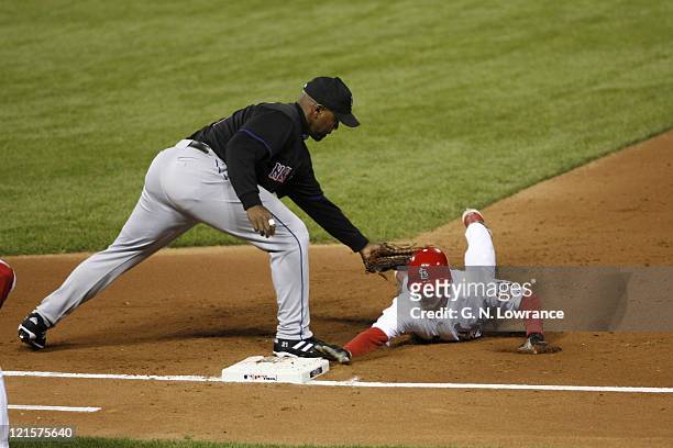 David Eckstein of the Cardinals is tagged out by Carlos Delgado on a pick off during game 3 of the NLCS between the New York Mets and St. Louis...