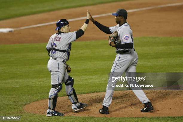 Mets catcher Paul Lo Duca congratulates Guillermo Mota following game 4 of the NLCS between the New York Mets and St. Louis Cardinals at Busch...