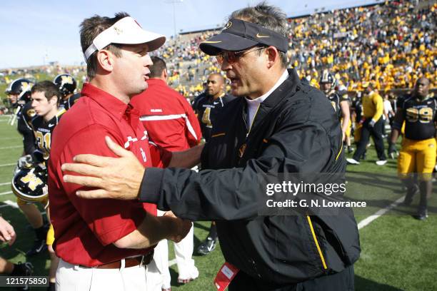 After the game head coaches Bob Stoops and Gary Pinkel meet on the field following a 26-10 Oklahoma win over the Missouri Tigers at Faurot Field in...
