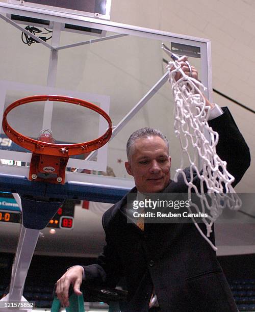 Head coach Larry Reynolds of the Long Beach State 49ers cuts down the net after a 94 to 83 win over the Cal Poly Mustangs in the championship game of...