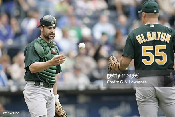 Oakland catcher Jason Kendall tosses the ball back to starting pitcher Joe Blanton versus the Kansas City Royals at Kauffman Stadium in Kansas City,...