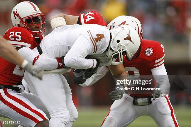 Limas Sweed of Texas is tackled by Andre Jones and Andrew Shanle during action between the Texas Longhorns and Nebraska Cornhuskers on October 21,...