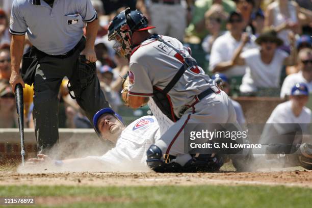 Braves catcher Todd Pratt tags out Michael Barrett at the plate during action between the Atlanta Braves and Chicago Cubs at Wrigley Field in...