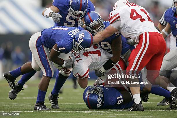 Members of the Kansas Jayhawks defense swarm Zac Taylor of the Nebraska Cornhuskers at Memorial Stadium in Lawrence, Kansas on November 5, 2005....