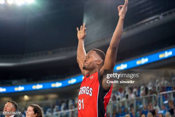 basketball player celebrating victory - basketball fans stock pictures, royalty-free photos & images