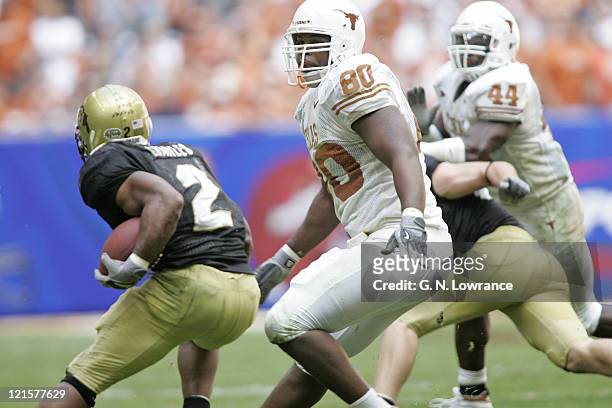 Tim Crowder of the Texas Longhorns pursues Hugh Charles of the Colorado Buffalos in the Big 12 Championship at Reliant Stadium in Houston, Texas on...