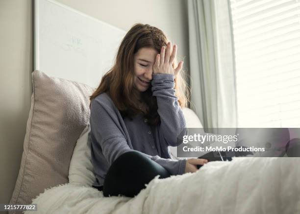 teenage girl using smartphone in bedroom - school avoidance stock pictures, royalty-free photos & images