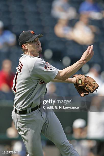 Jason Johnson of the Detroit Tigers fields and throws a bunted ball during a game against the Kansas City Royals at Kauffman Stadium in Kansas City,...