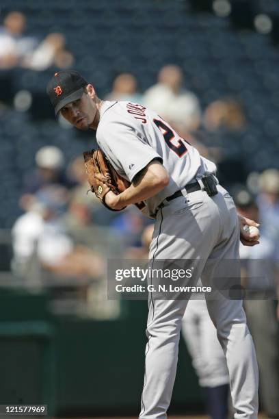 Starting pitcher Jason Johnson of the Detroit Tigers glances over to a runner on first base during a game against the Kansas City Royals at Kauffman...