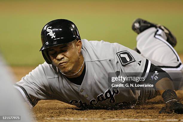 Chicago's Alex Cintron dives back into first base during action between the Chicago White Sox and Kansas City Royals at Kauffman Stadium in Kansas...