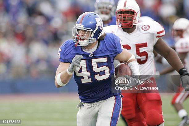 Linebacker Kevin Kane of the Kansas Jayhawks returns an interception for a 4th-quarter touchdown during a game against the Nebraska Cornhuskers at...