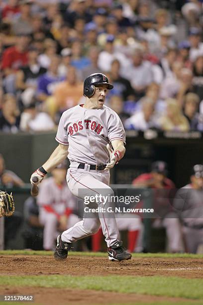 Bill Mueller of the Boston Red Sox knocks in a run with a double against the Kansas City Royals at Kauffman Stadium in Kansas City, Mo. On August 25,...